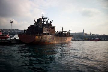 Fototapeta premium Burned ship on the port