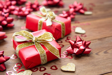 Obraz na płótnie Canvas Red gift box with bows, on wooden background. Copy space. Valentine's day, birthday, Christmas.