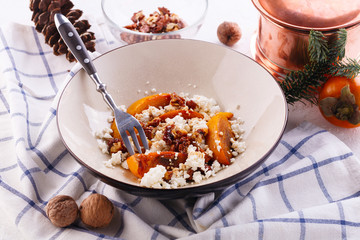 Winter dessert. caramelized persimmon with walnuts and cottage cheese