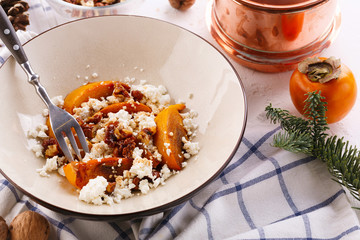 Winter dessert. caramelized persimmon with walnuts and cottage cheese