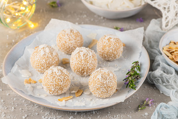 Homemade sweet white chocolate and coconut in a plate. Raffaello candy - snowball truffles on a Christmas table.