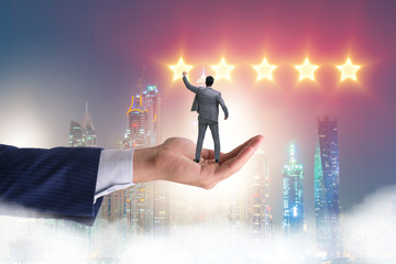 Businessman held on hand reaching out for stars
