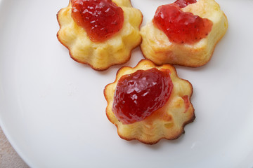 A portion of cottage cheese casserole with strawberry jam and peaches
