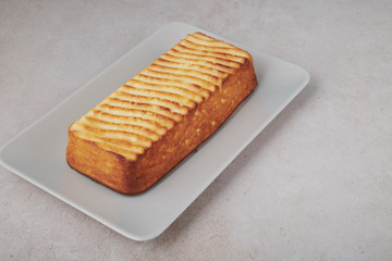 A portion of cottage cheese casserole with strawberry jam and peaches