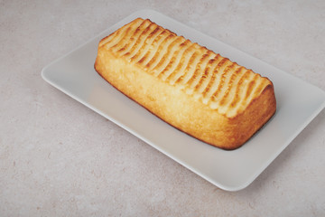 A portion of cottage cheese casserole with strawberry jam and peaches