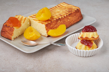 A portion of cottage cheese casserole with strawberry jam and peaches