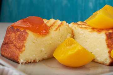 A portion of cottage cheese casserole with strawberry jam and peaches
