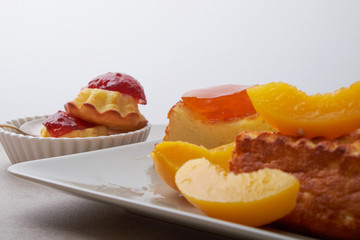 A portion of cottage cheese casserole with strawberry jam and peaches