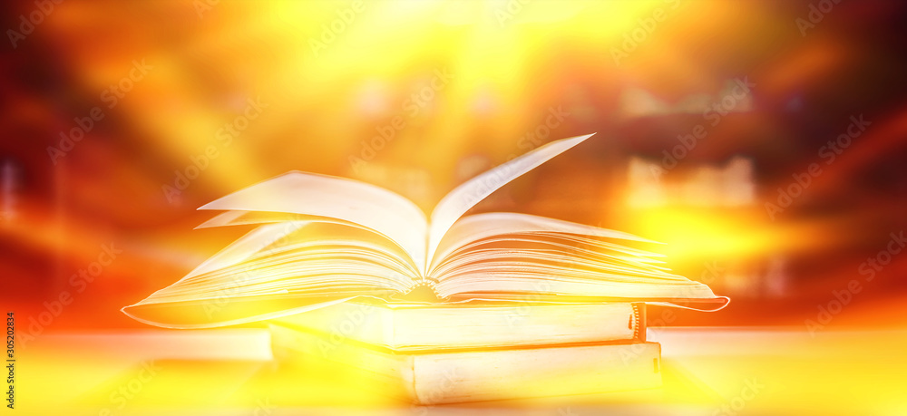 Poster imagine a picture book of an ancient book opened on a wooden table with a sparkling golden backgroun