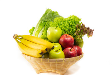 Bio-organic salad vegetables, apples, bananas in a basket. Good for health. Diet in the white background.