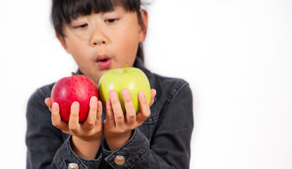 Fototapeta na wymiar The image of an Asian girl holding a red and green apple in his hand is healthy and good for a white background.