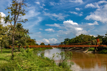 Obraz premium A bridge over river Nam Xong, Laos. View of nature around Vang Vieng, Vientiane Province.
