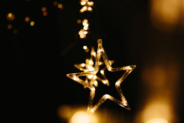 Christmas lights on dark background. Star shaped.
