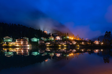 Fototapeta na wymiar Nightshot of the Masare village at Lago di Alleghe lake in South Tyrol