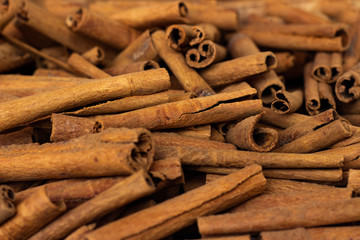 Heap of cinnamon sticks close-up.