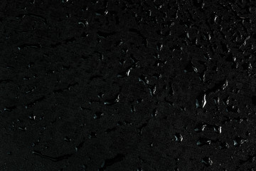 black flat rubber surface with water drops dark macro background - obrazy, fototapety, plakaty