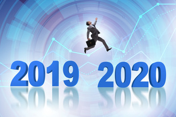 Businessman jumping from year 2019 to 2020