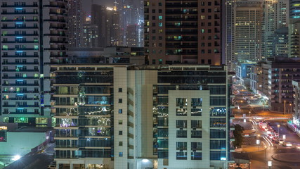 Fototapeta na wymiar Dubai Marina skyscrapers and promenade aerial night timelapse, Dubai, United Arab Emirates