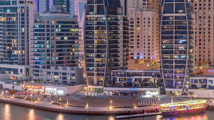 Fototapeta na wymiar Dubai Marina skyscrapers, port with luxury yachts and Marina promenade aerial day to night timelapse, Dubai, United Arab Emirates