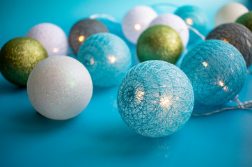 Christmas tree decorations with tinsel and garland on blue background for Christmas.