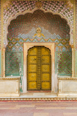 Golden door of the Peacock Gate at the city palace in Jaipur, India