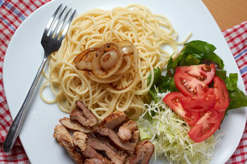 The homemade spaghetti dish serving in white plate