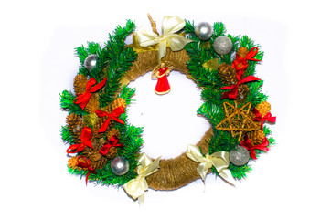Fototapeta na wymiar Christmas wreath. Wreath on the door, the wall. Home decoration interior. Christmas wreath in macro, individual elements, angel. Ball, star. DIY wreath. Merry Christmas.