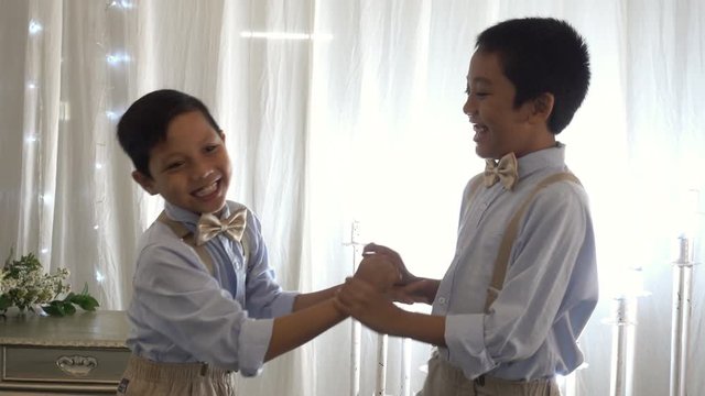 Two friends or brothers laughing and having fun in bohemian outfit style