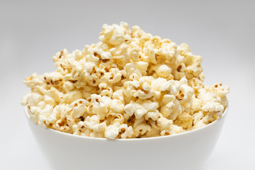 Popcorn in white big bowl isolated on white background