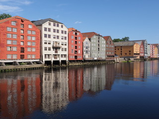 Fabulous buildings reflected in water at Nidelva river in european Trondheim city at Trondelag district in Norway