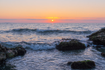 Colorful sunrise on a rocky seashore