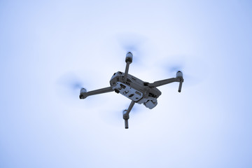 Naklejka na ściany i meble A camera drone flying in the air