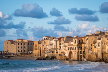 Seafront of Tyrrhenian Sea and Medieval houses of Sicilian coastal medieval city Cefalu in sunset
