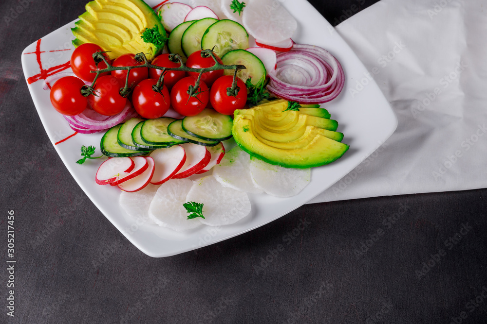 Wall mural fresh salad close up cherry tomatoes and avocado on a rustic dark wooden table