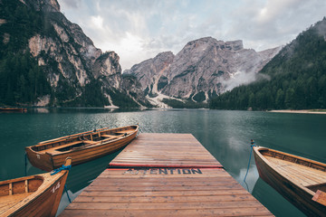 Natural landscapes of the lake Braies (Lago di Braies) with morning fog and sunlight on the...