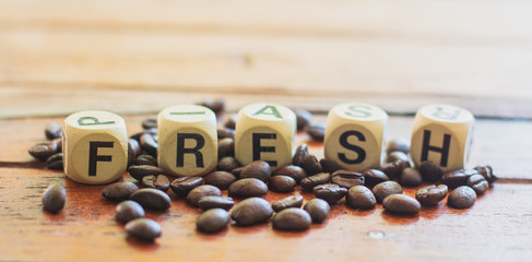 Fresh on wooden block with group of coffee beans on table. fresh and enery beverage concept.