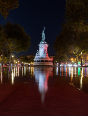 Paris by night the monument to the Republic with the symbolic statue of Marianna, in Place de la Republique water reflection white color