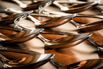 Macro of cutlery spoons on wooden table