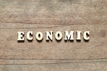 Letter block in word economic on wood background