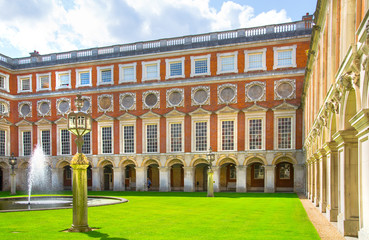 London, UK. English garden view and the East Front of Hampton court 17th century locates West London