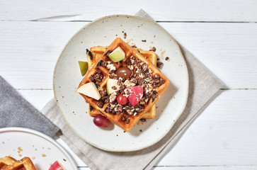 Homemade waffles with fruit and granola..