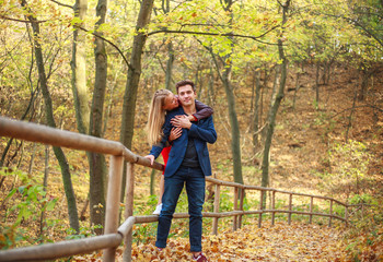 Naklejka na ściany i meble Guy with girl happy couple together in forest park