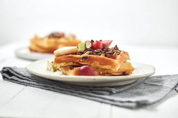 Homemade waffles with fruit and granola..