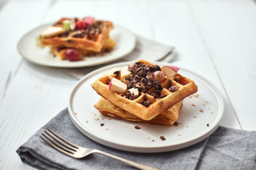 Homemade waffles with fruit and granola..