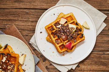 Homemade waffles with fruit and granola..