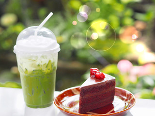Ice beverage green tea with soft cocoa cake in wonderful garden