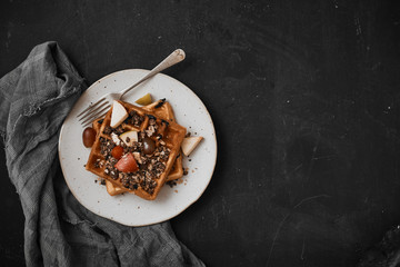 Homemade waffles with fruit and granola..