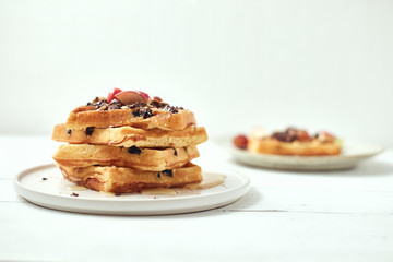 Homemade waffles with fruit and granola..