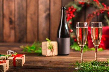 Naklejka na ściany i meble champagne and new year, christmas or noel (champagne glass, sparkling wine and gifts on the table) menu concept. food background. copy space. Top view