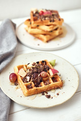 Homemade waffles with fruit and granola..